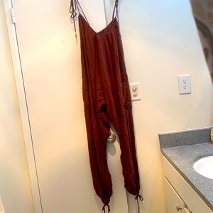 Jumpsuit.Ties at shoulder and bottom.Brand new